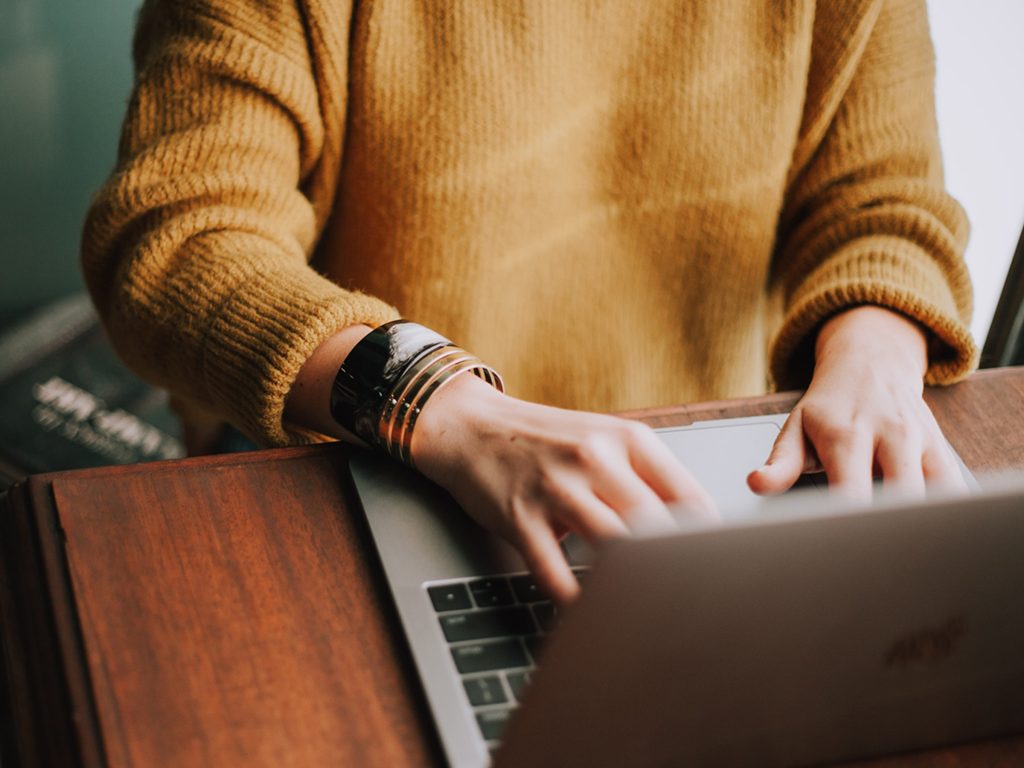 Office Worker At Desk On MacBook Pro